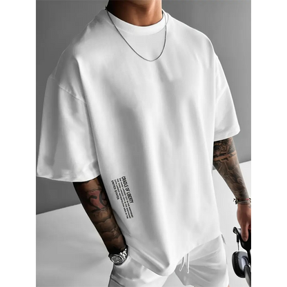 ✨ Camisa de manga corta de corte ancho para hombre – mezcla de algodón premium, estampado gráfico urbano y estilo🏙️ oversize casual